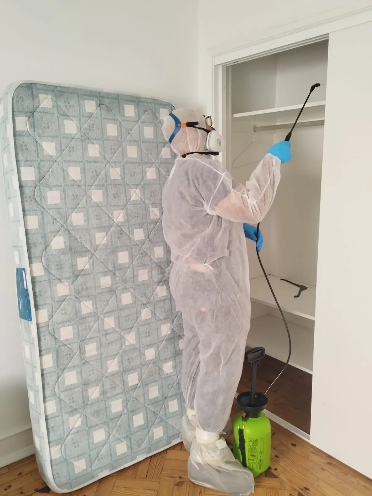 Técnico da PragaFix com equipamento de proteção a realizar tratamento num quarto